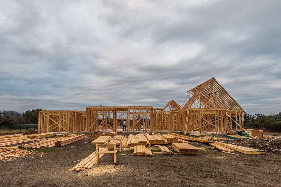Wooden house framing under construction in Fort Worth, TX during a cloudy day.